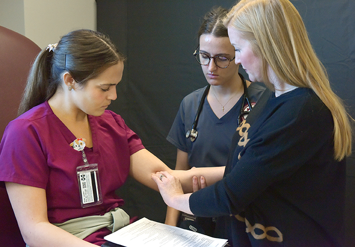 Dr. Shey Washburn works with students in MSU-Meridian’s Master of Physician Assistant Studies in the Interprofessional Simulation Lab on the Riley Campus.