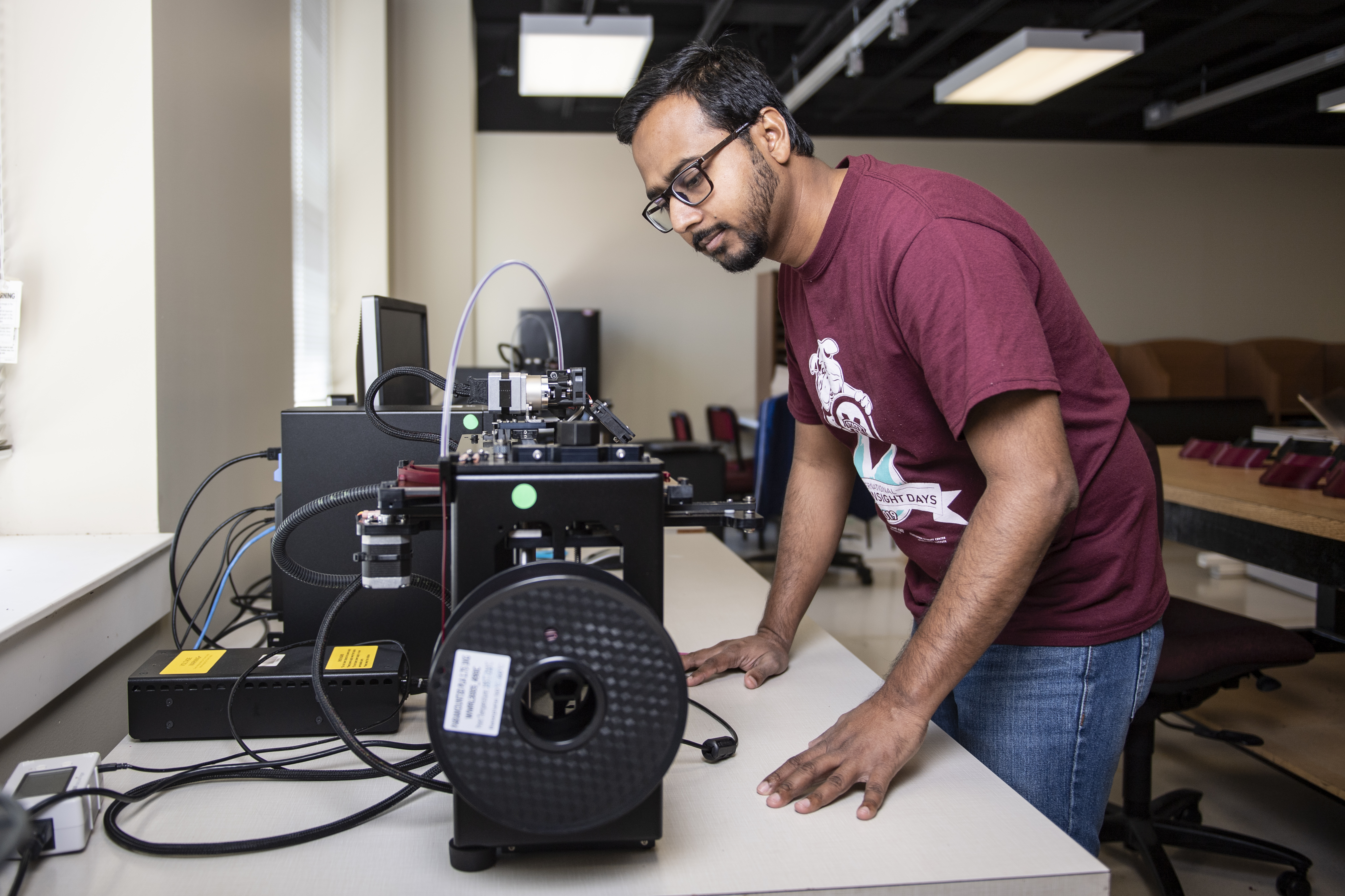 Abdullah Al Mamun, an MSU industrial and systems engineering doctoral student from Bangladesh, works to 3D print face shields in McCain Hall. (Photo by Logan Kirkland)