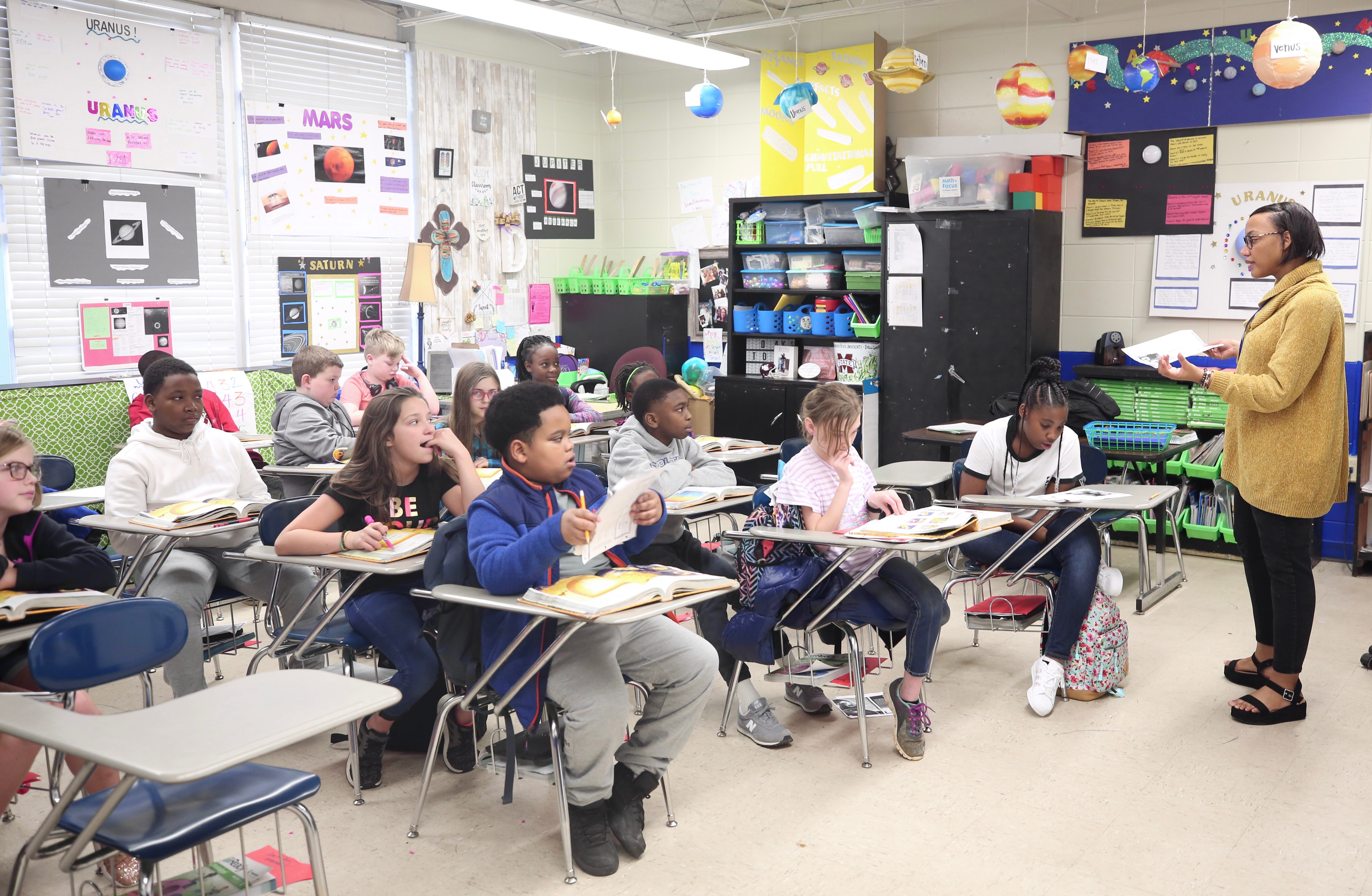 Dre'Anna Davis, a fifth grade teacher at Quitman Upper Elementary works with students in her classroom. (Photo provided by Quitman School District)