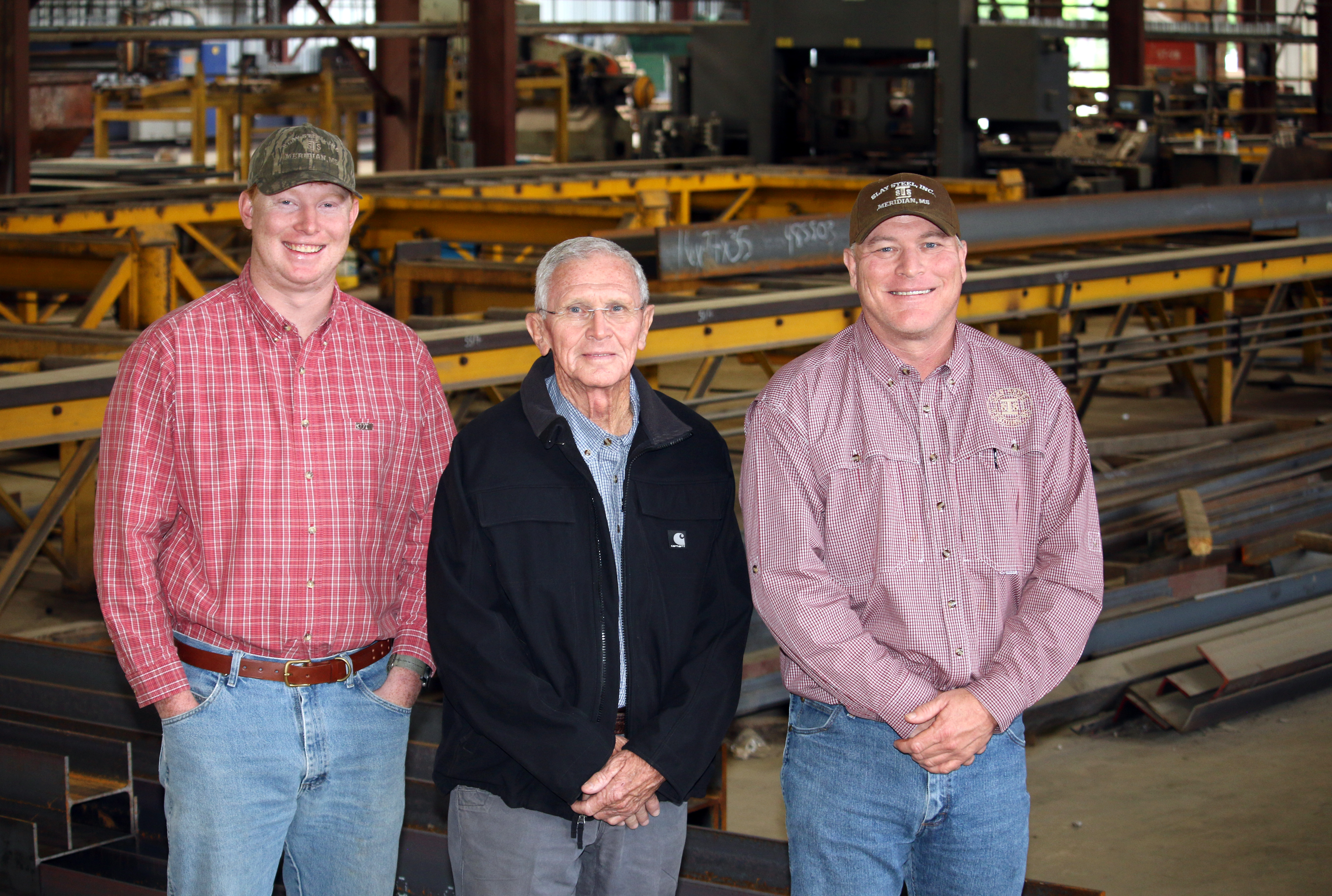 Garrett Slay, Ronnie Slay and Greg Slay inside Bay 3 of the fabrication shop at Slay Steel.  (Photo by Lisa Sollie) 