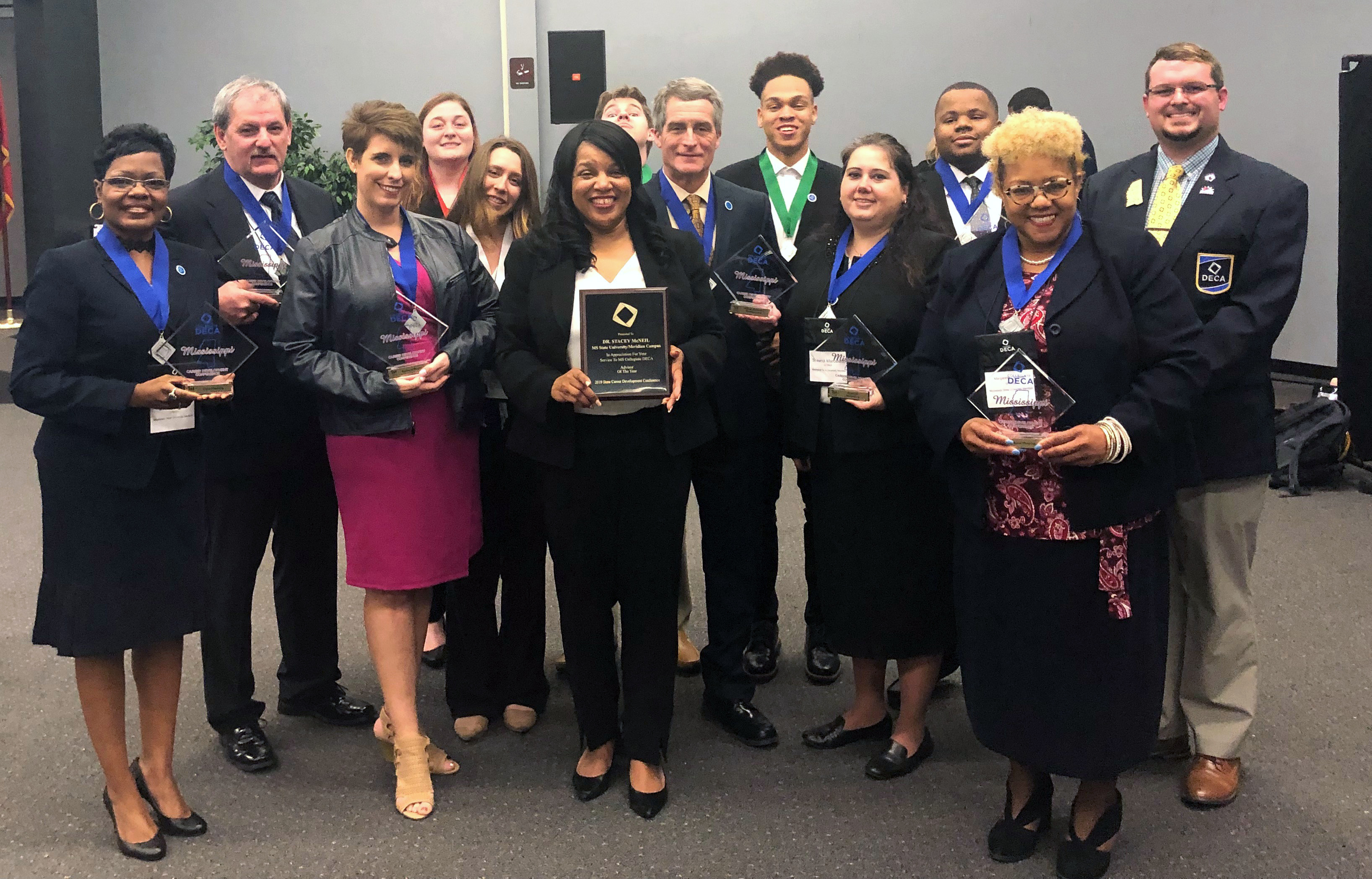Dr. Stacey McNeil (front, third from left) was named Mississippi Collegiate DECA Advisor of the Year at the 2019 statewide convention. Here she is surrounded by MSU-Meridian DECA members, who turned in strong performances in the conference competitions.