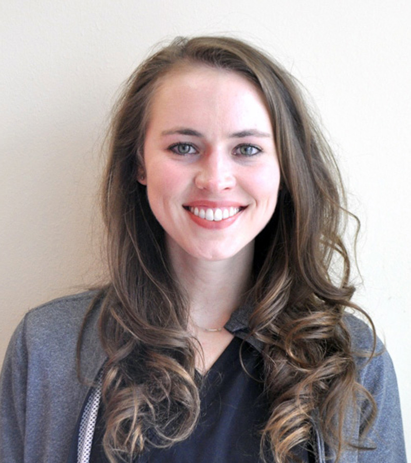 Photo of Megan Hatch, PharmD, BCPS with long curly hair.