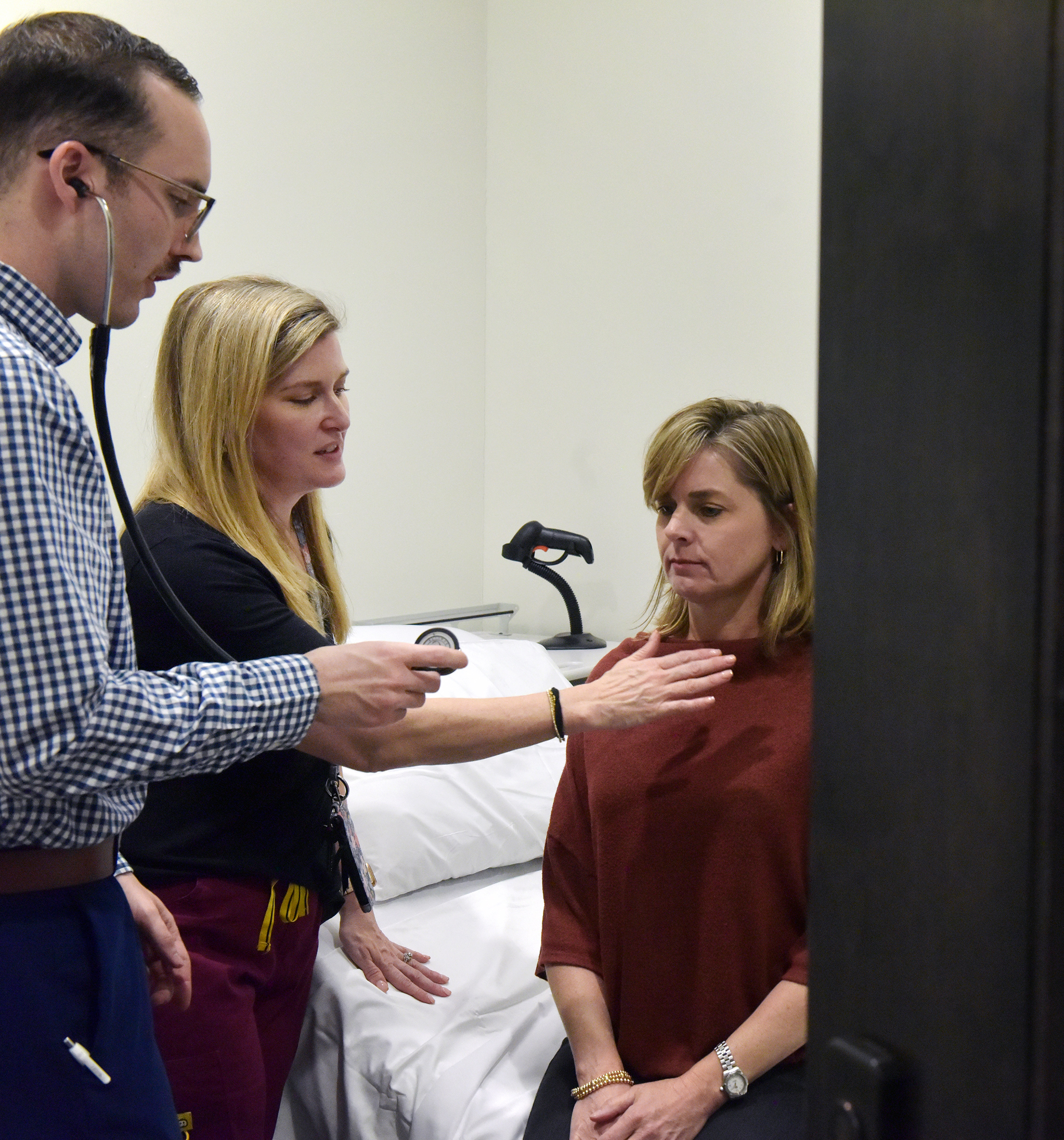 Alaina Herrington works in the Interprofessional Simulation Lab with Tyler Tyree, a PA student, and Standardized Patient Cassie Carroll.  (Photo by Marianne Todd)