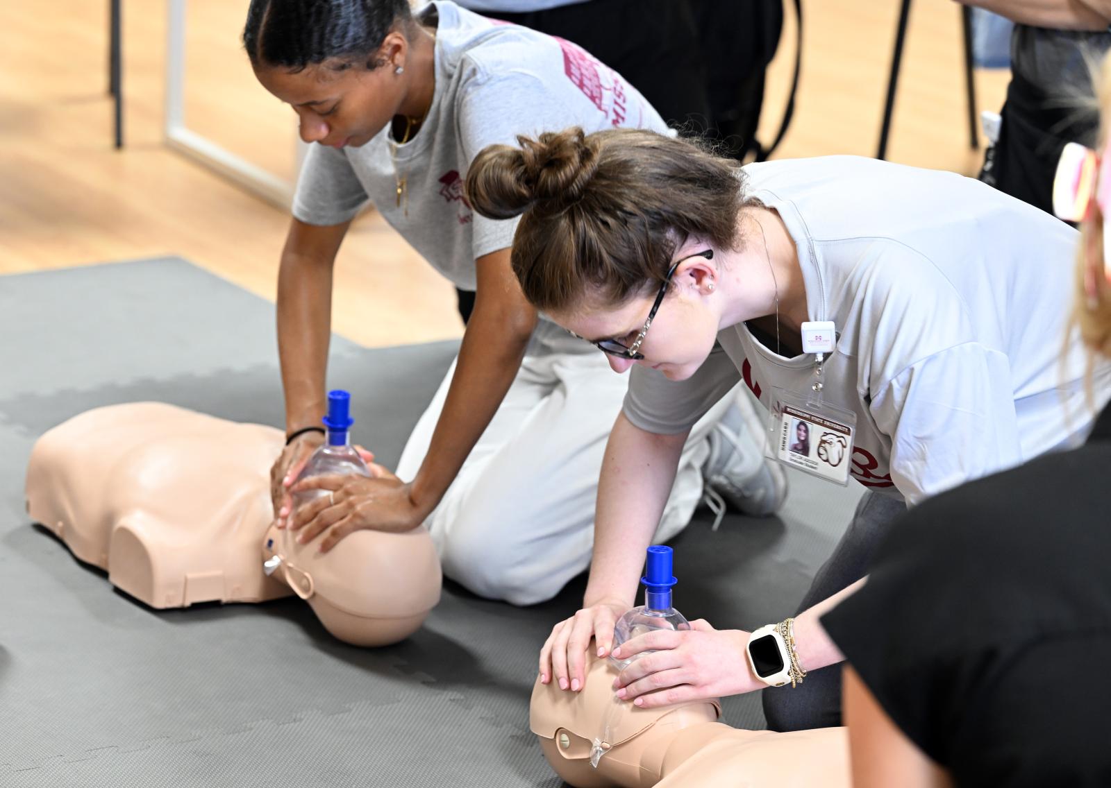 Students giving cpr for practice