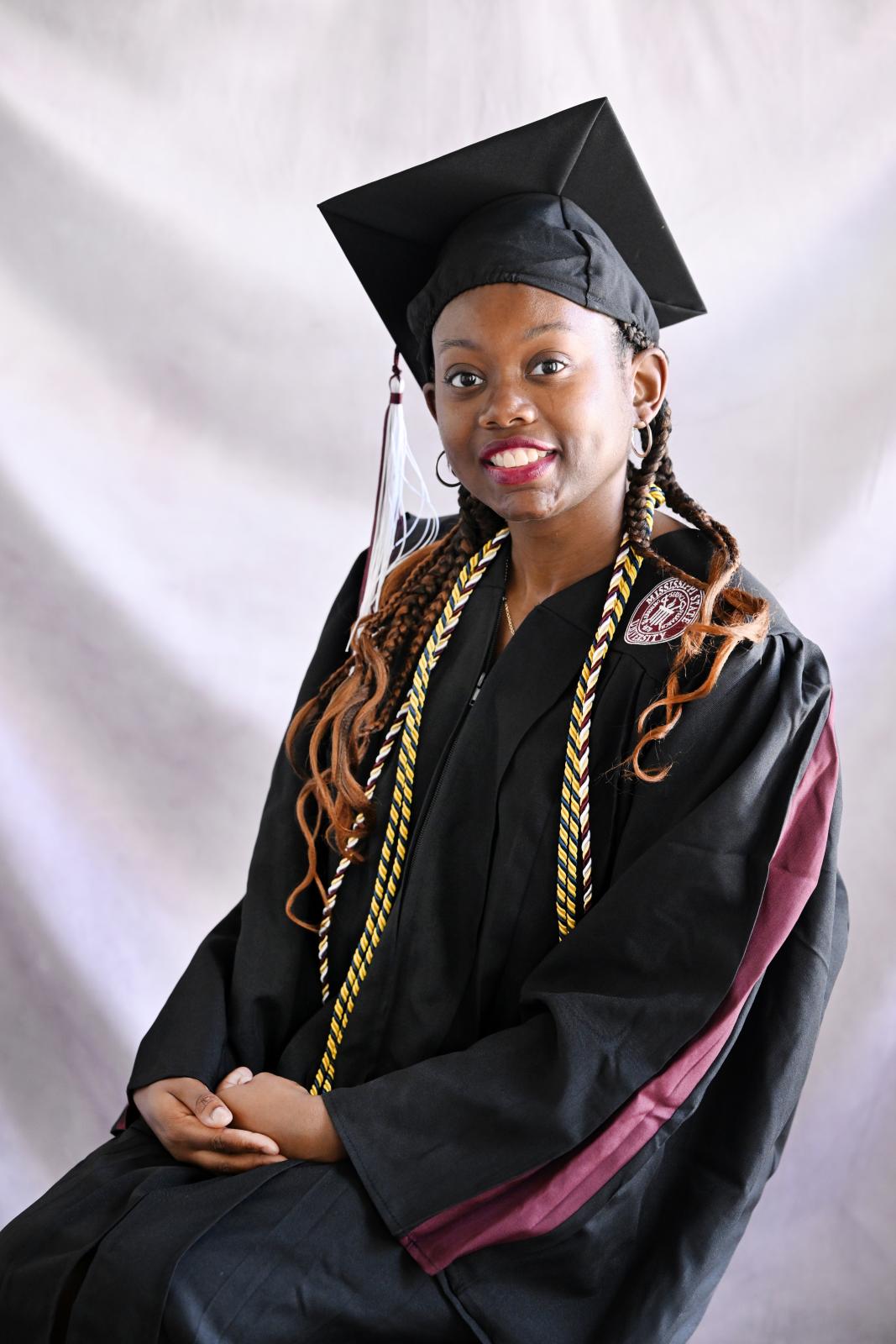 Photo of Jamesa Bias in cap and gown with cords