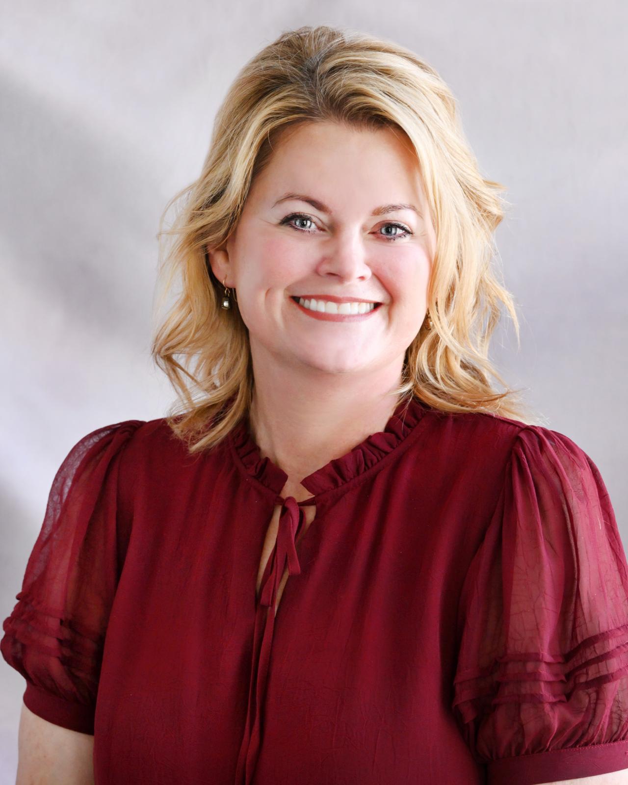 Photo of Mary Smith in maroon blouse