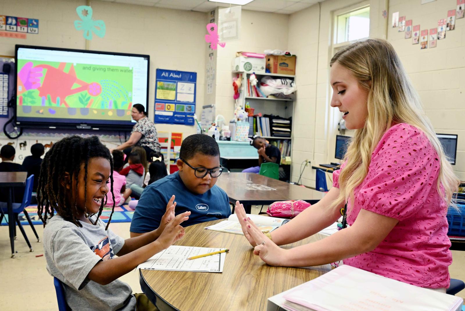 Victoria Pigg in classroom working with students.