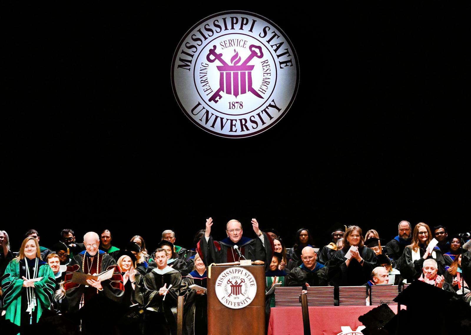 MSU President Mark E. Keenum congratulates new MSU-Meridian graduates Wednesday [May 13] after conferring degrees during commencement exercises at the MSU Riley Center. (Photo by Marianne Todd)