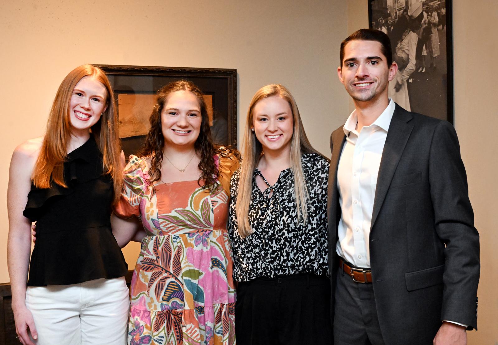 Four students smiling at camera